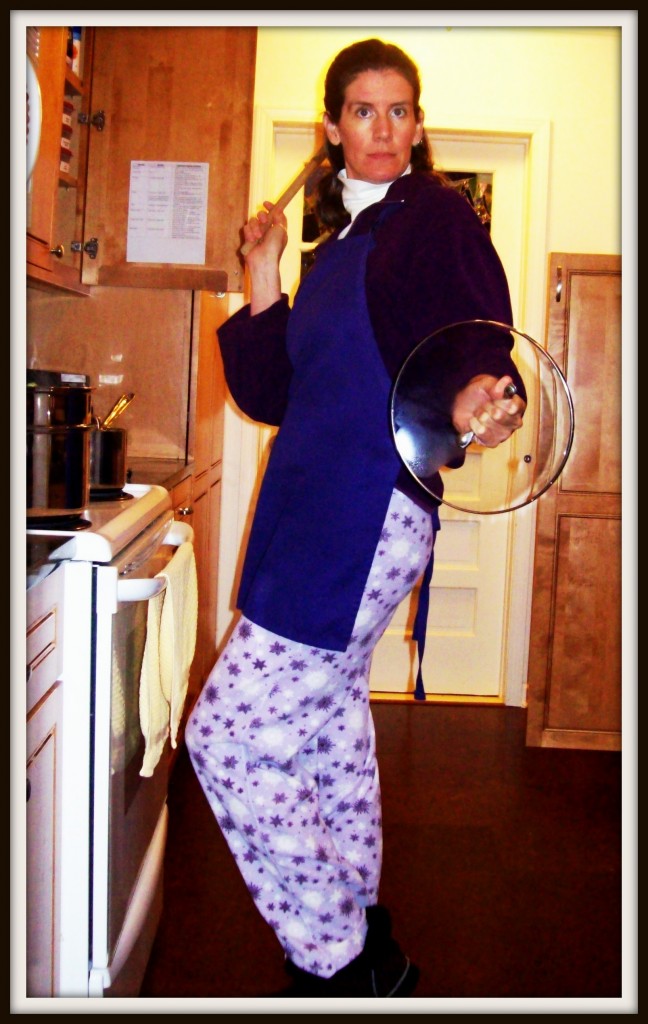 Eileen wearing purple pajamas and a purple apron while cooking