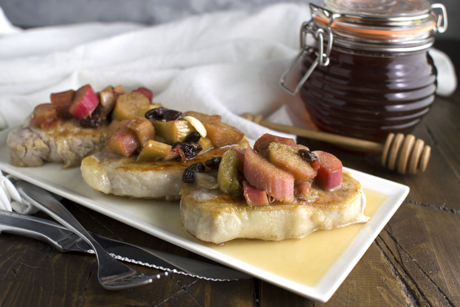 pork chops on a tray with chutney on top