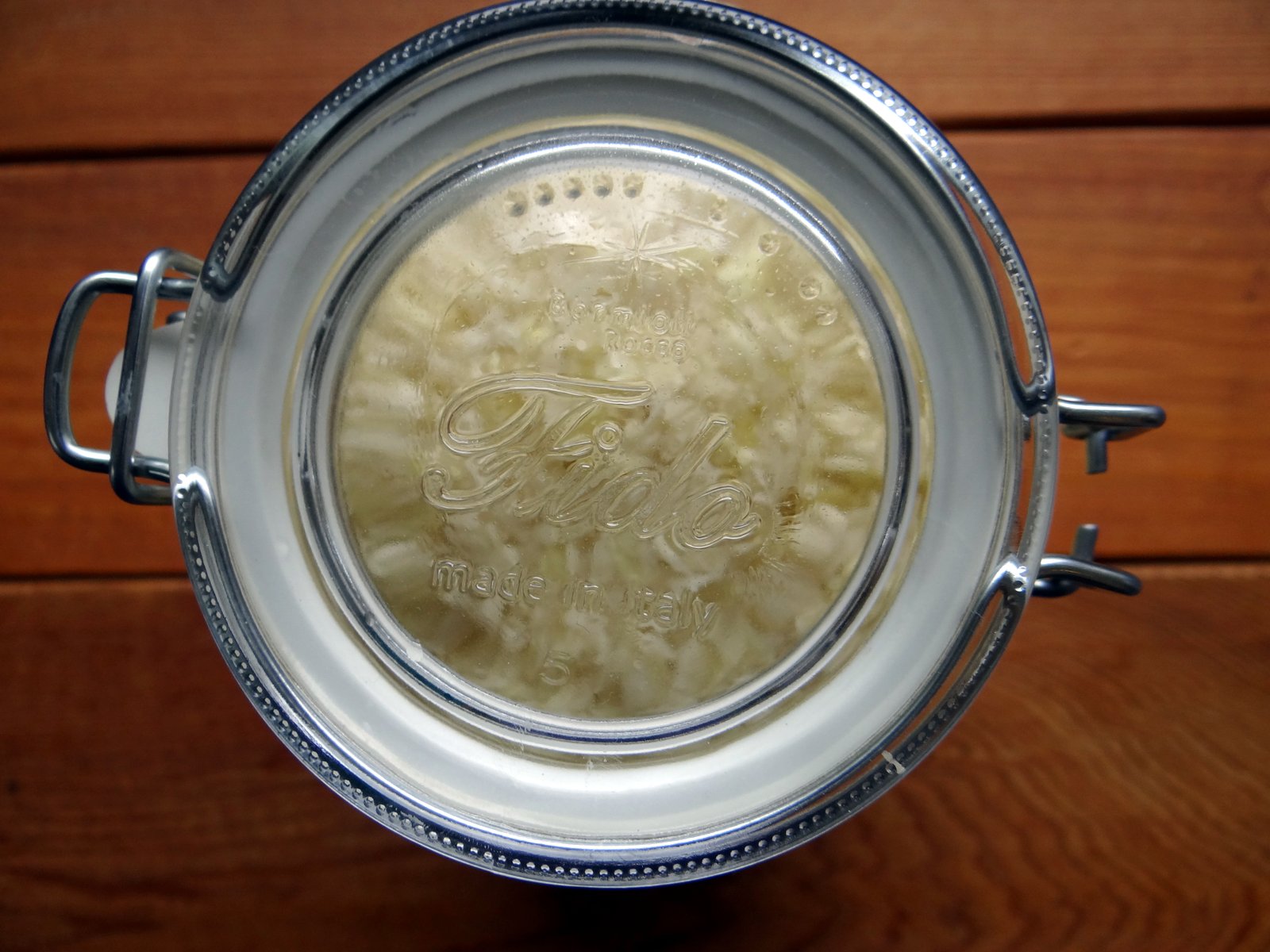 top of a fido jar with a batch of sauerkraut inside