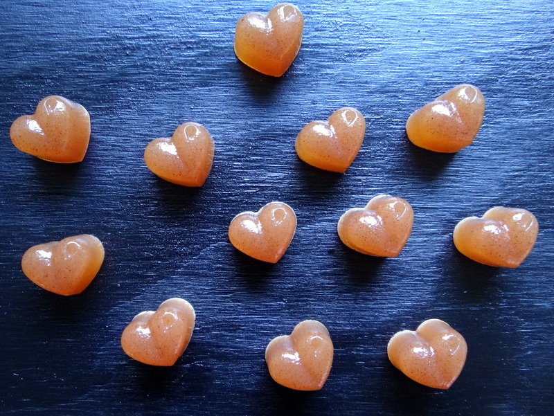 heart shaped gummies on a black background