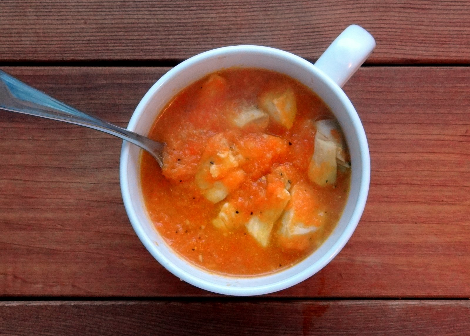 bowl of soup, bright orange in color from the carrots