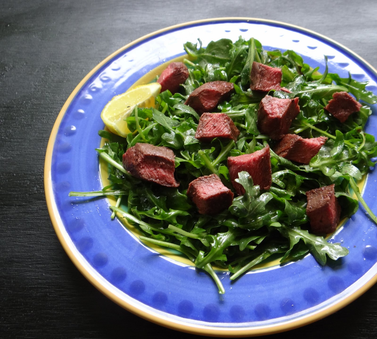 photo of steak salad on a plate