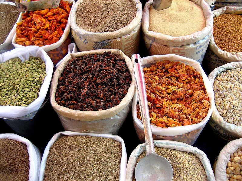 Bulk spices in baskets at an outdoor market