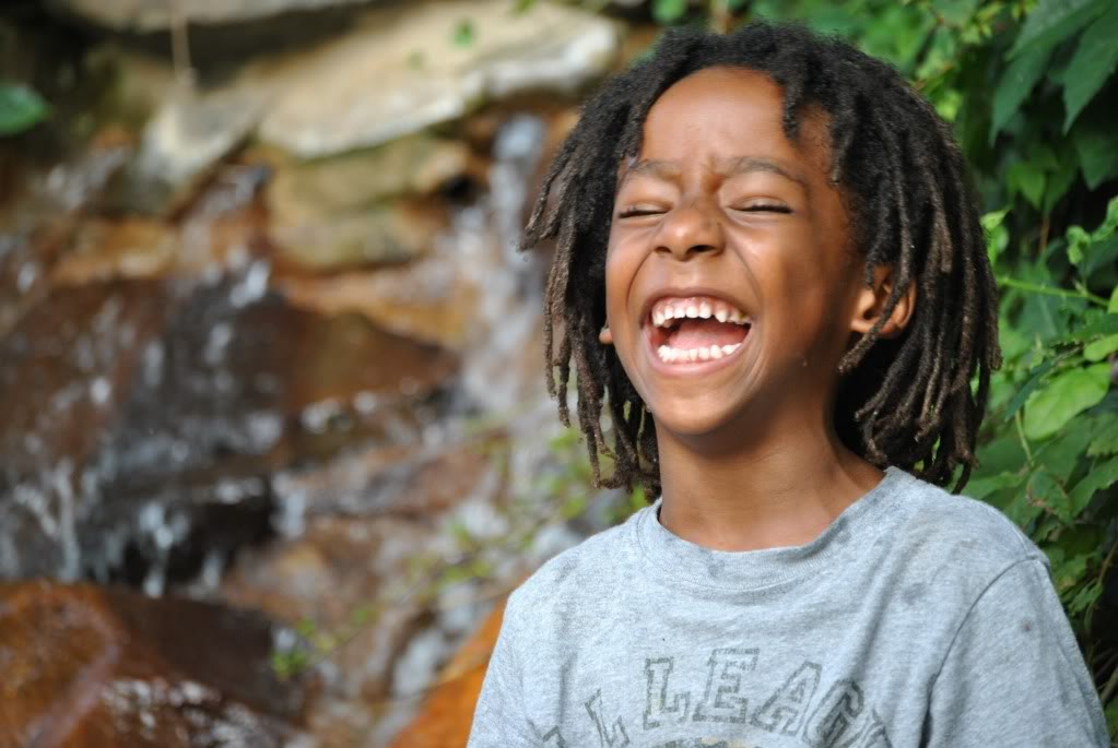 Boy laughing with eyes closed