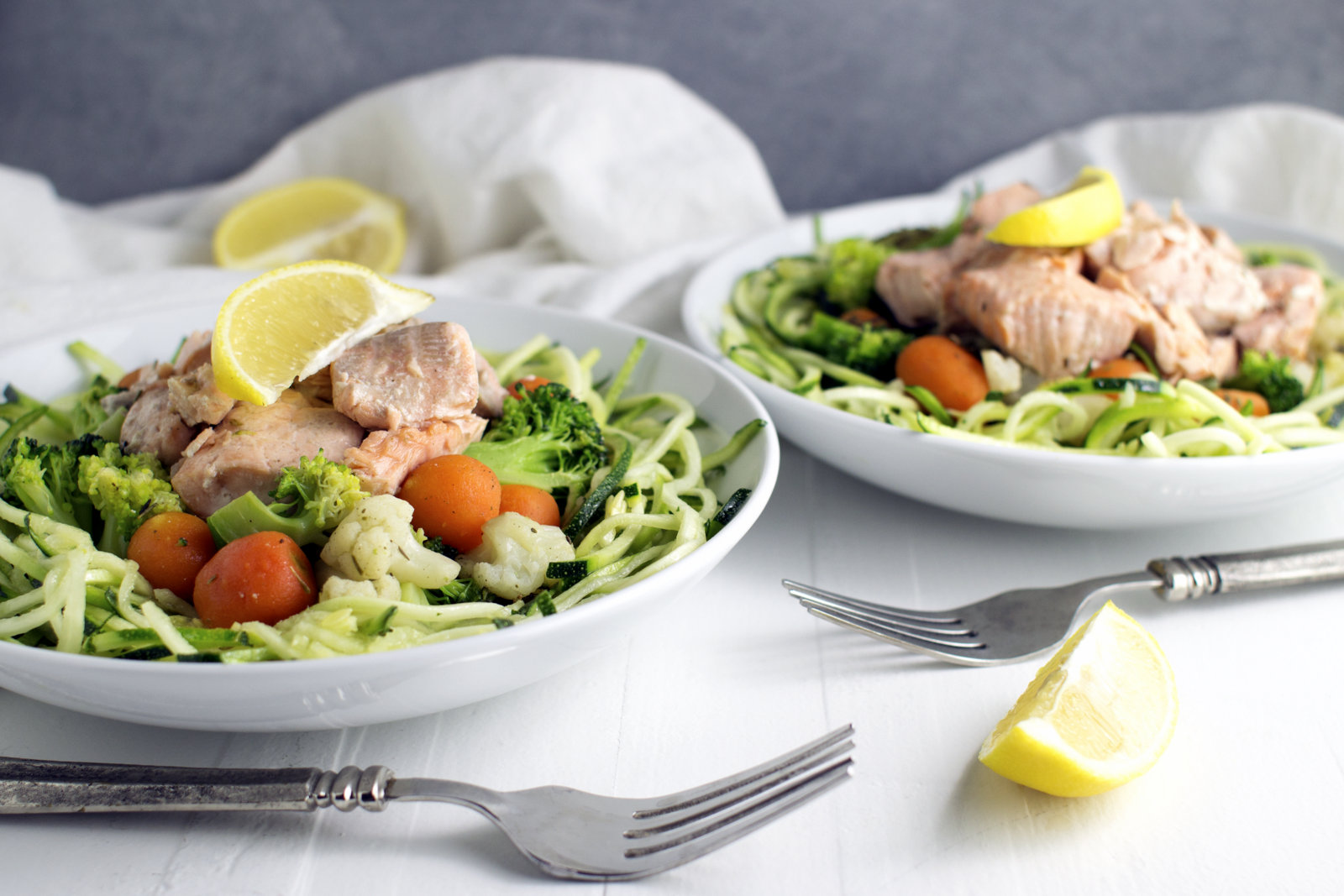 2 servings of the cooked recipe, in white bowls with silver forks alongside