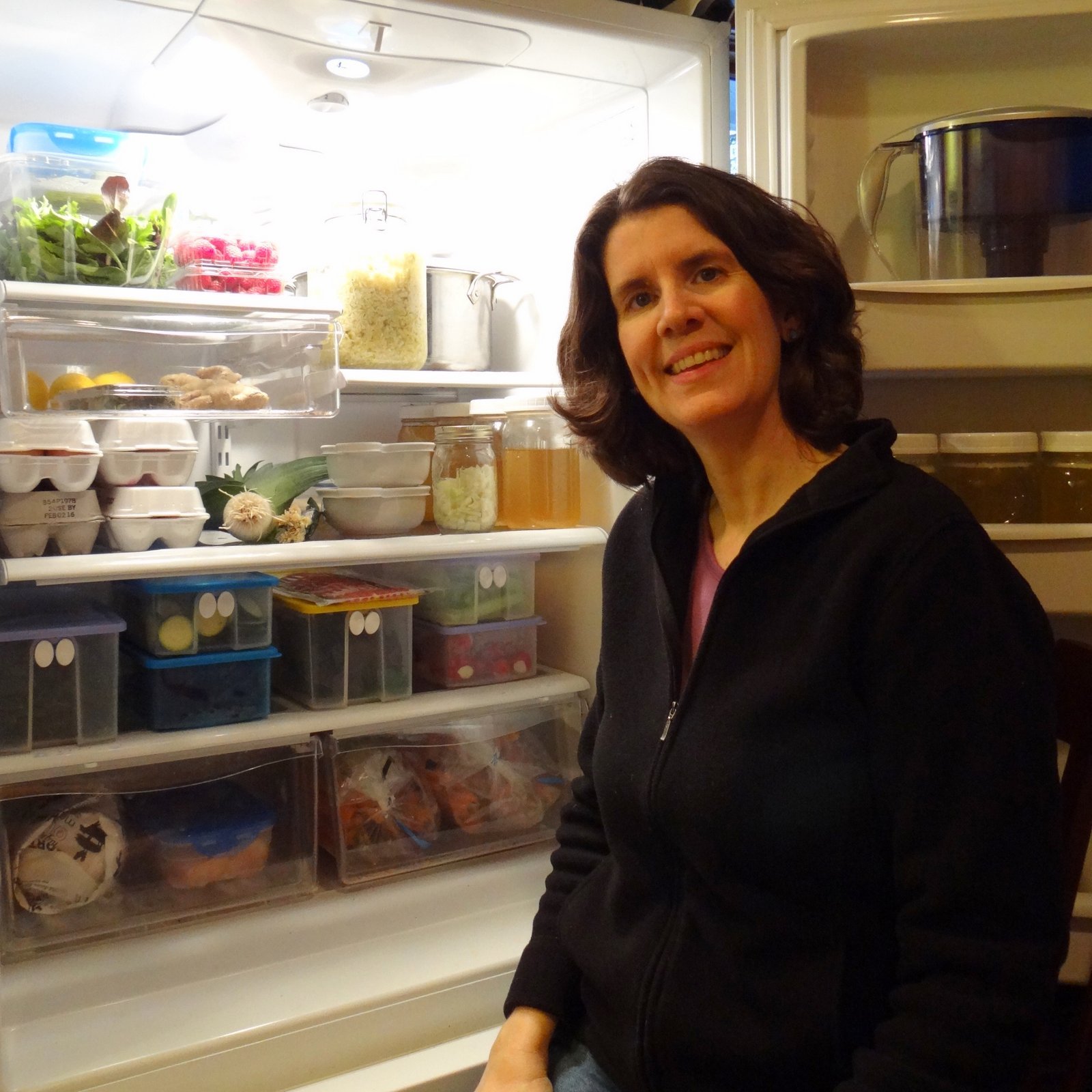 Eileen standing in front of the open door of her fridge