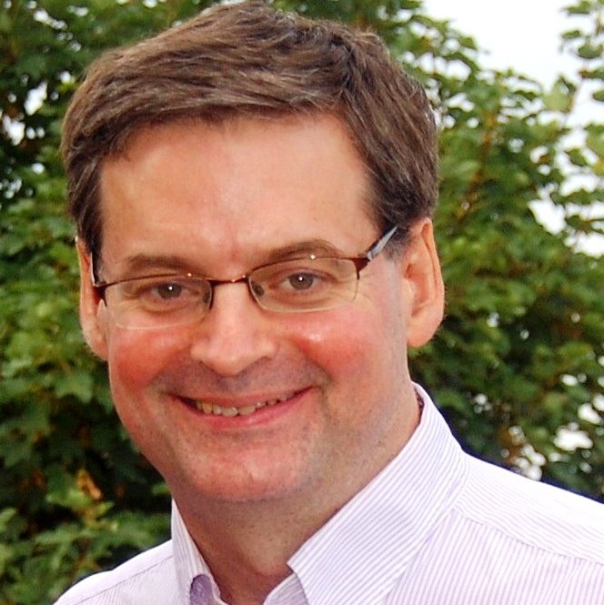 headshot photo of Paul, smiling