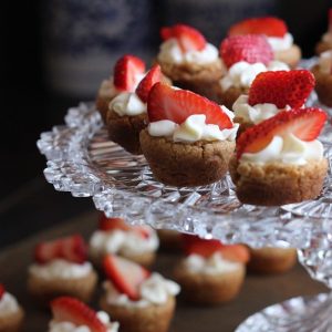 mini cupcakes with frosting and strawberries on top