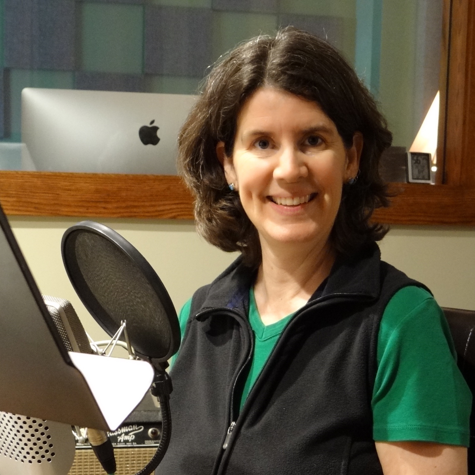 Author smiling in front of the microphone