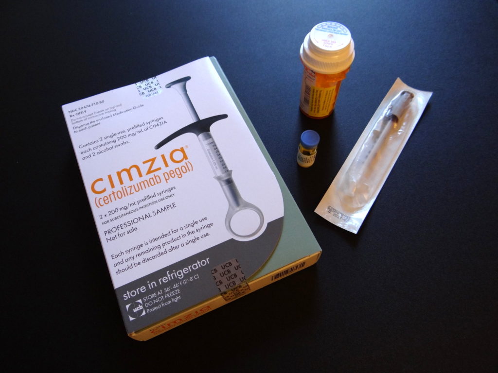 box of cimzia, vial of methotrexate, prescription bottle, and syringe.