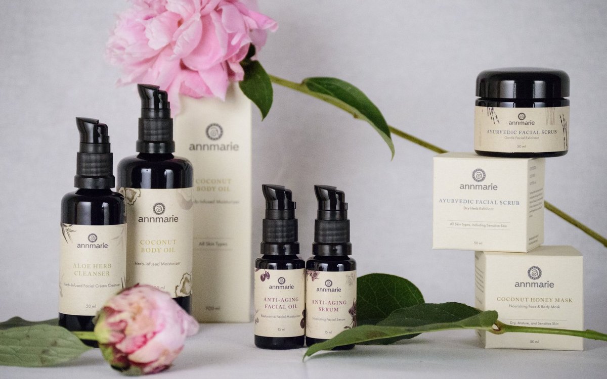 annmarie skincare products arranged with flowers