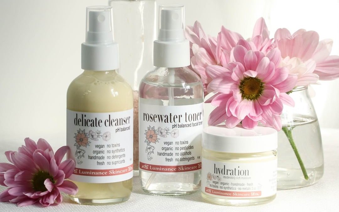 luminance skincare products arranged with flowers
