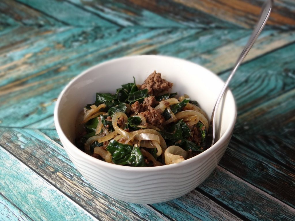 the recipe served in a white bowl on a teal wooden background