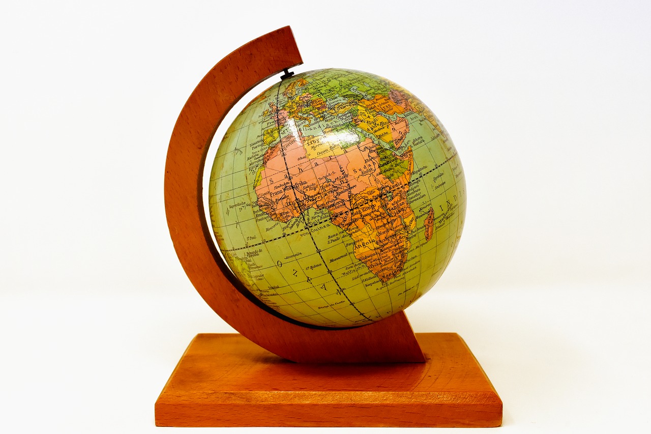 a wooden globe on a pedestal