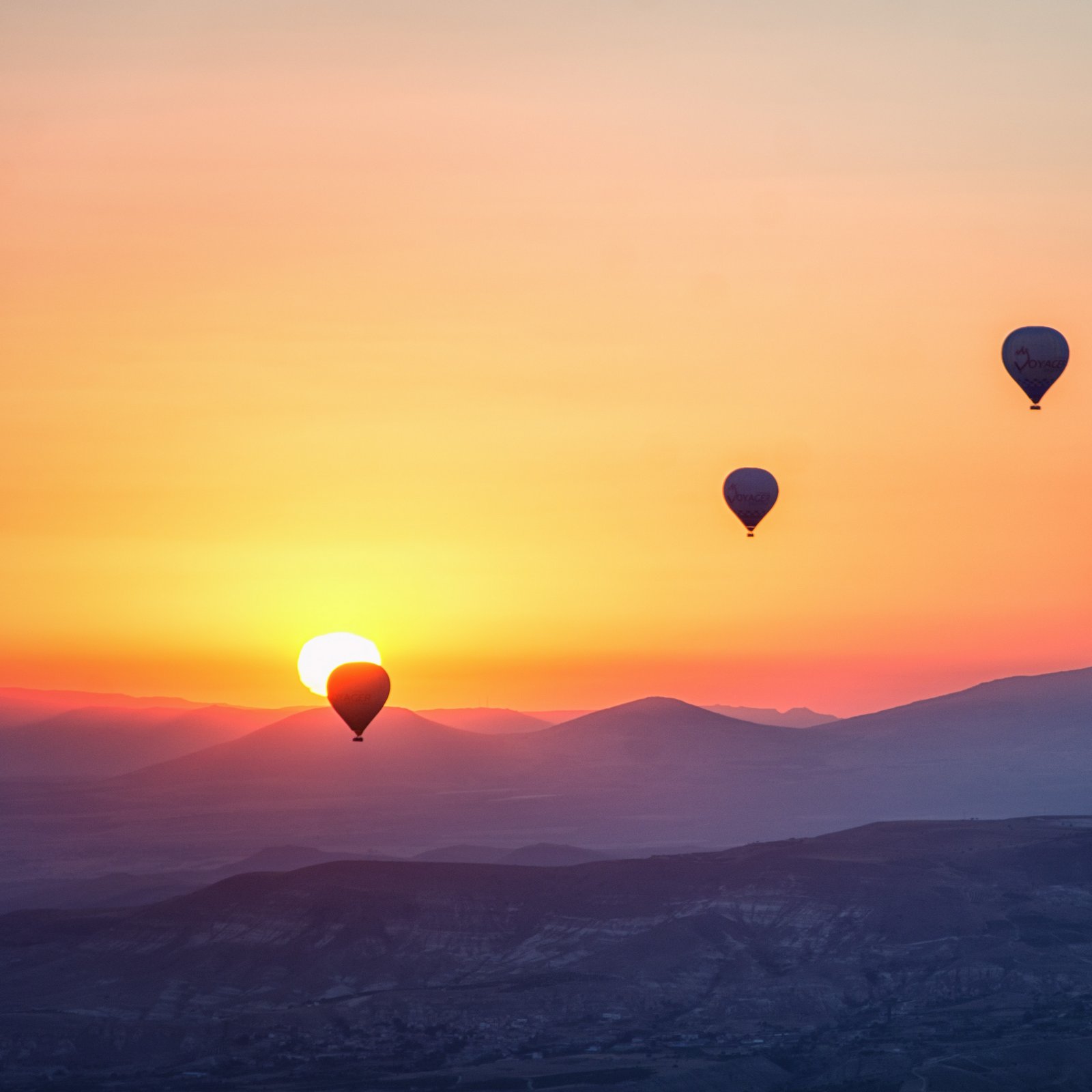 3 hot air balloons rising in the sky