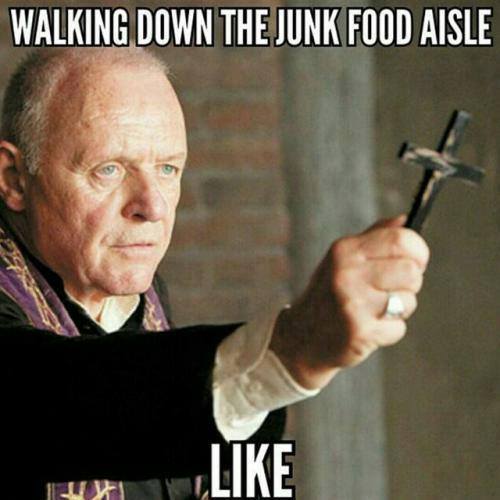 Walking down the junk food aisle like (photo of priest holding a cross)