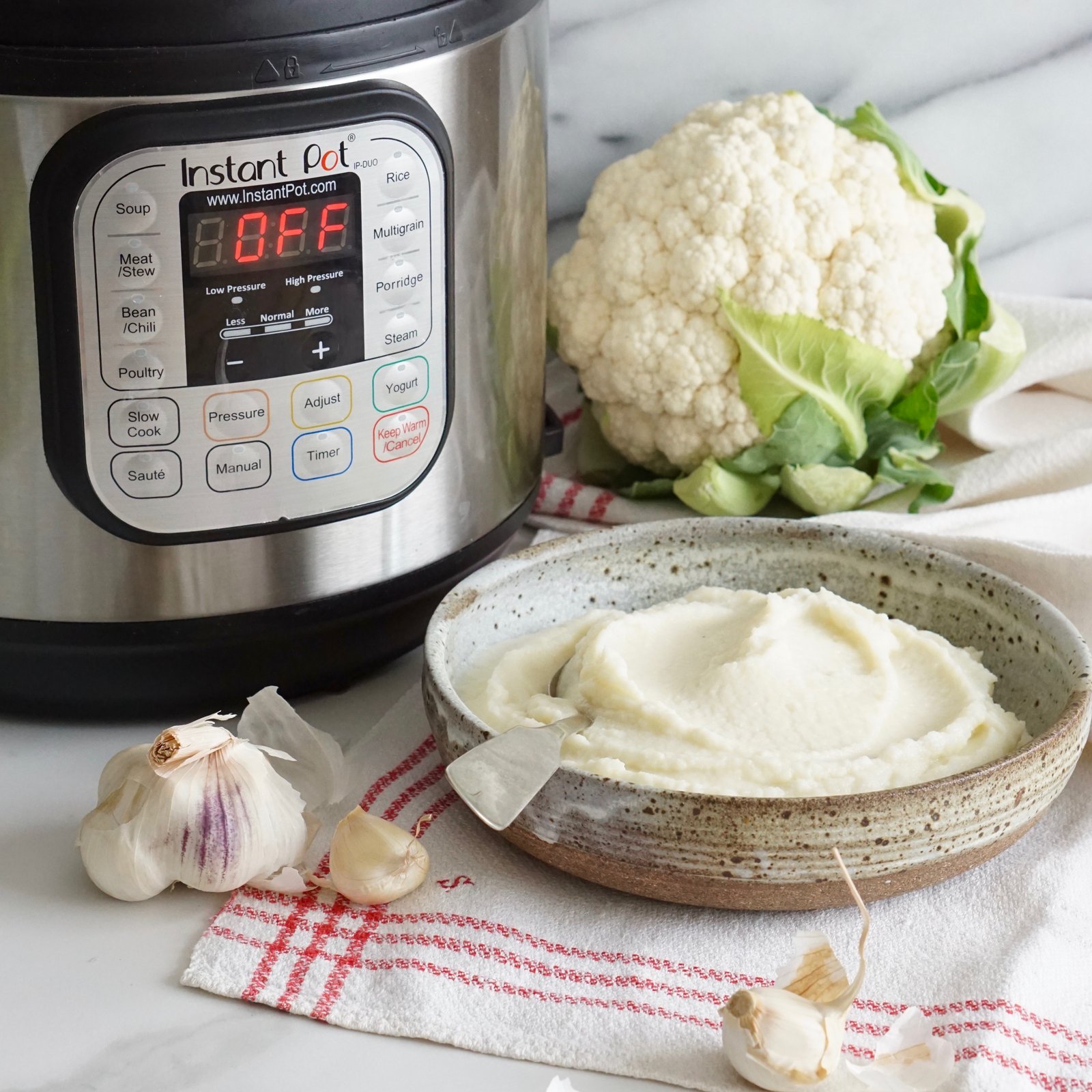 photo of instant pot with bowl of mashed cauliflower alongside