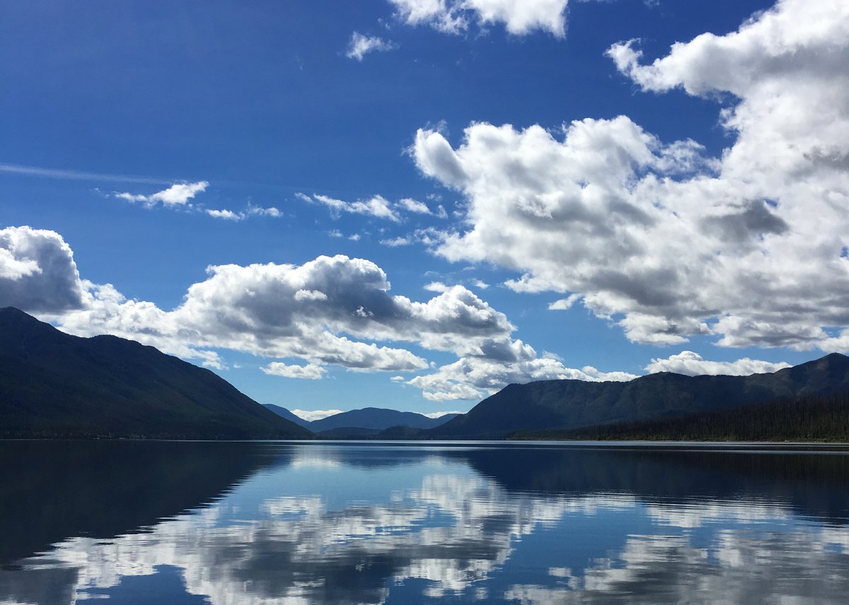 mountains surrounding a lake under a bright blue sky