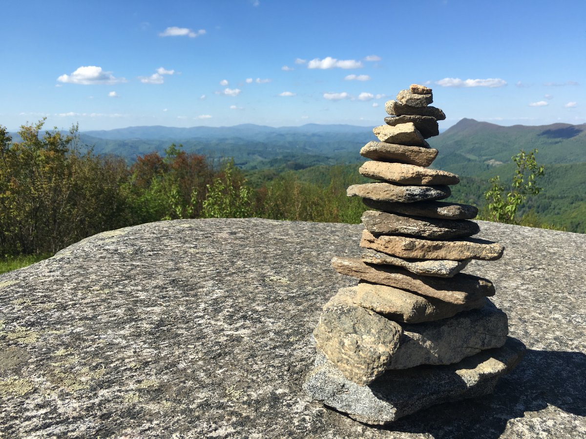 a stack of stones balanced in a beautiful nature setting