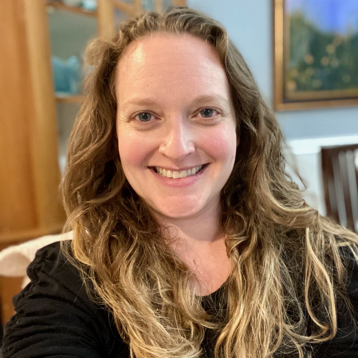 Headshot of Lauren with long blond hair, wearing a black shirt