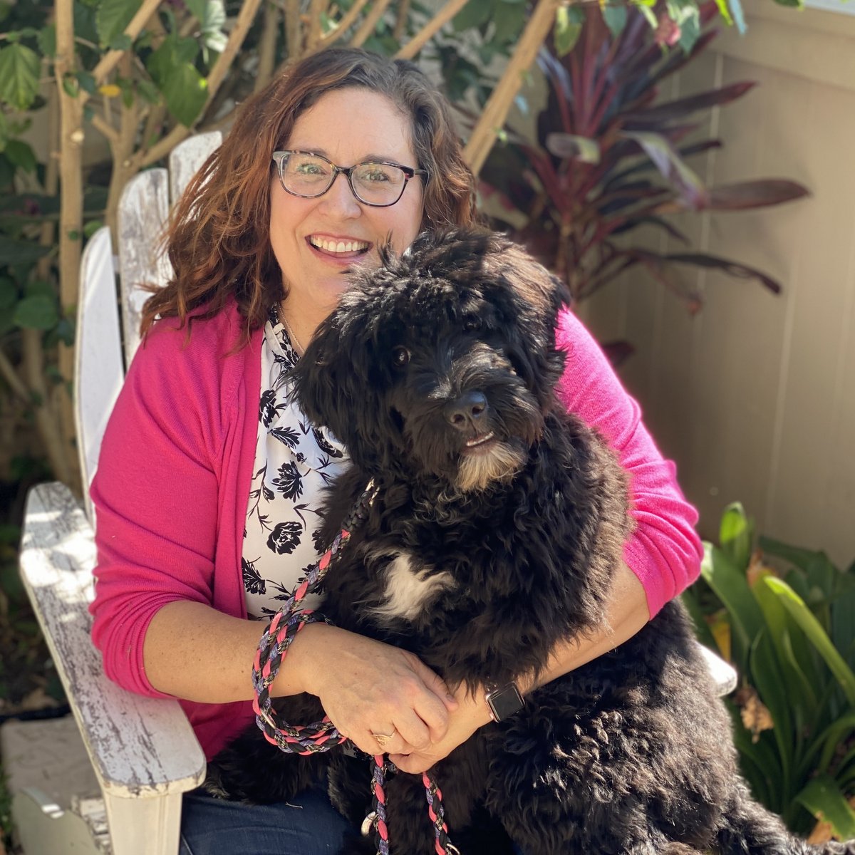 Kendra's gluten-detection dog sitting in her lap