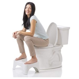 squatty potty positioned in front of toilet