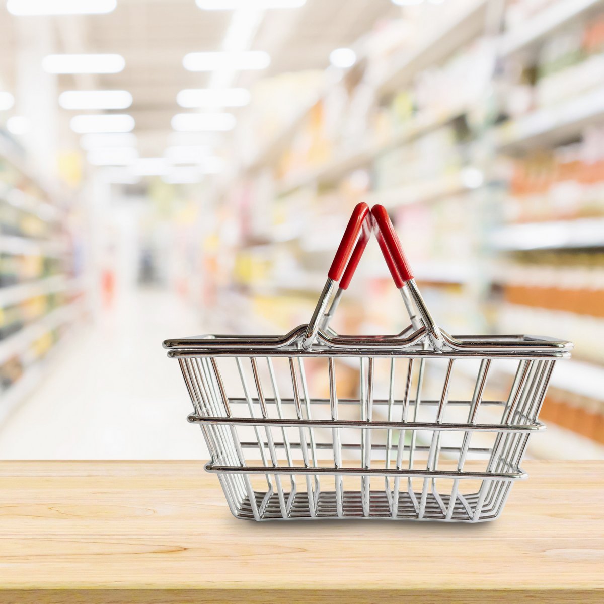 wire shopping basket on counter in grocery store