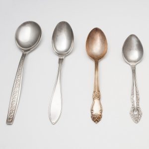 a set of varied antique spoons