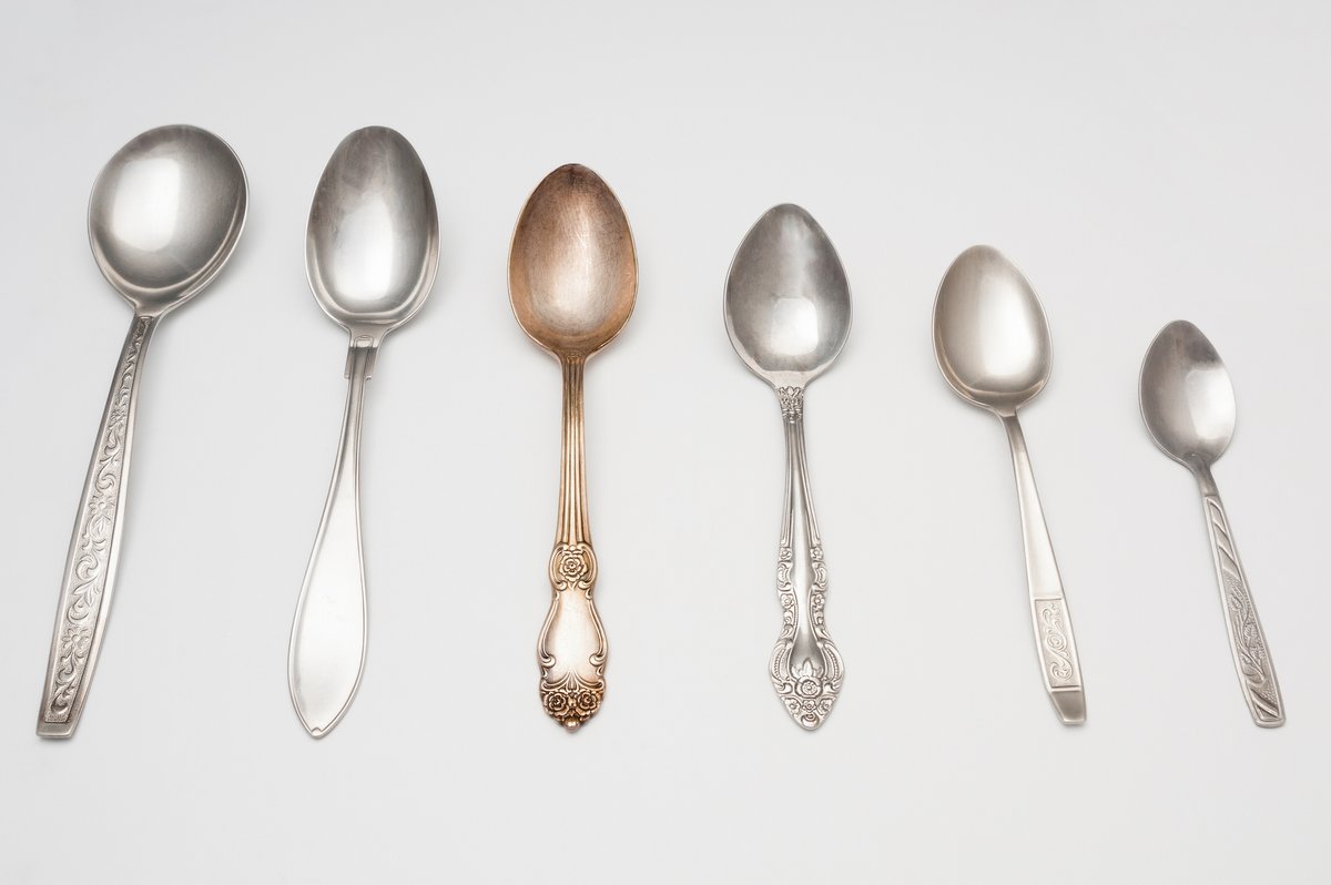 a set of varied antique spoons